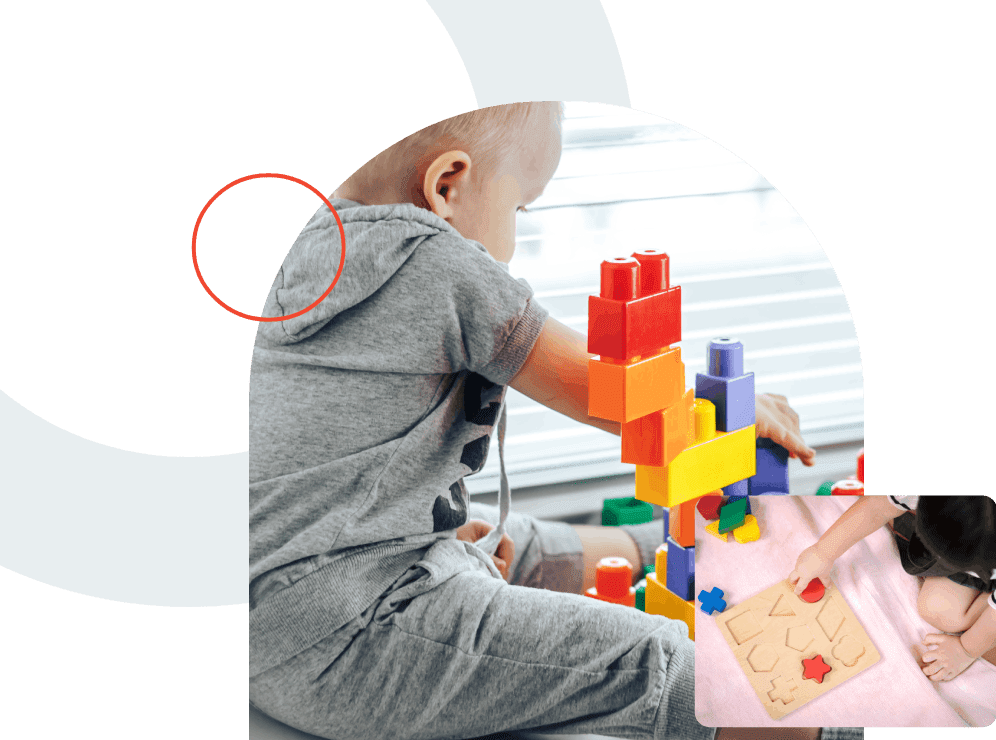 Little boy build pyramid toys at home