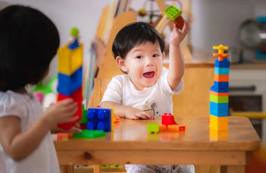 Kids playing with colorful plastic blocks